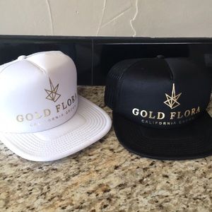 Gold Flora cannabis branded flat bill trucker hat